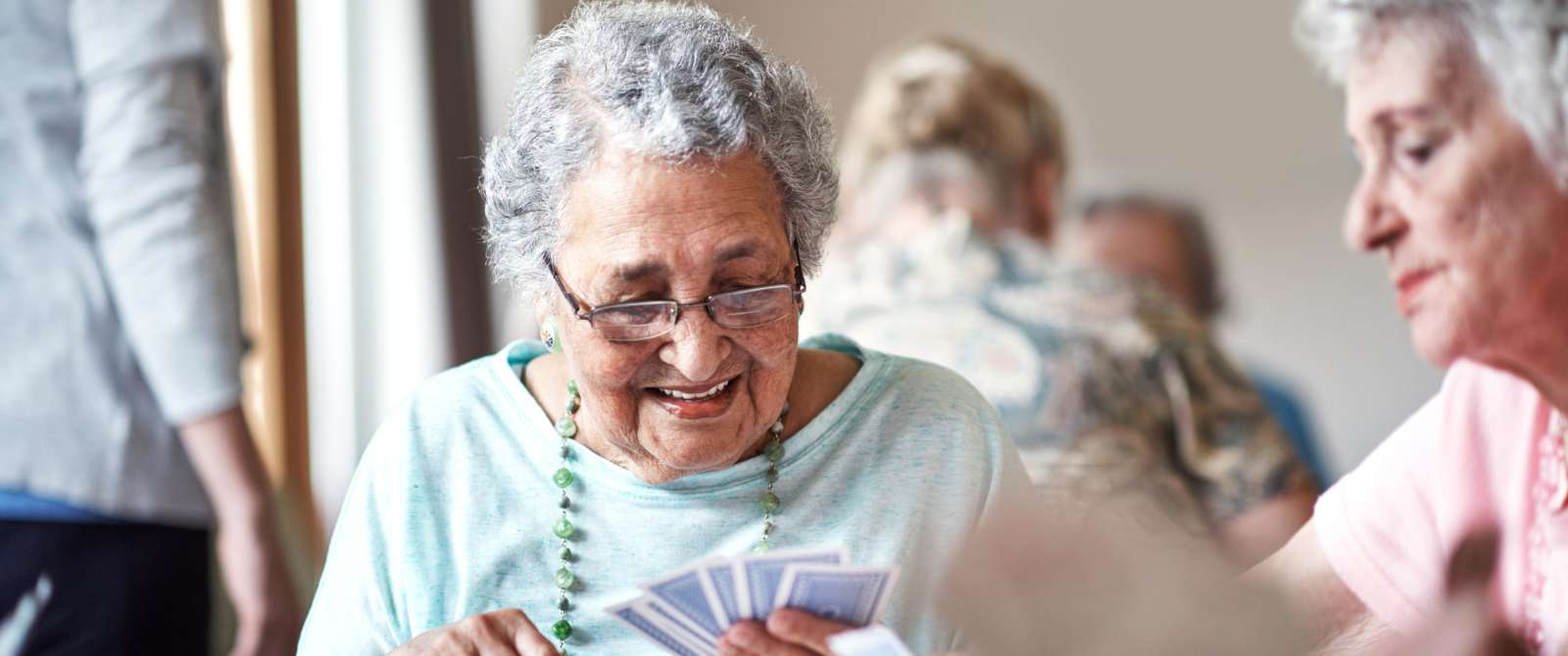 Elder woman playing cards with her friend