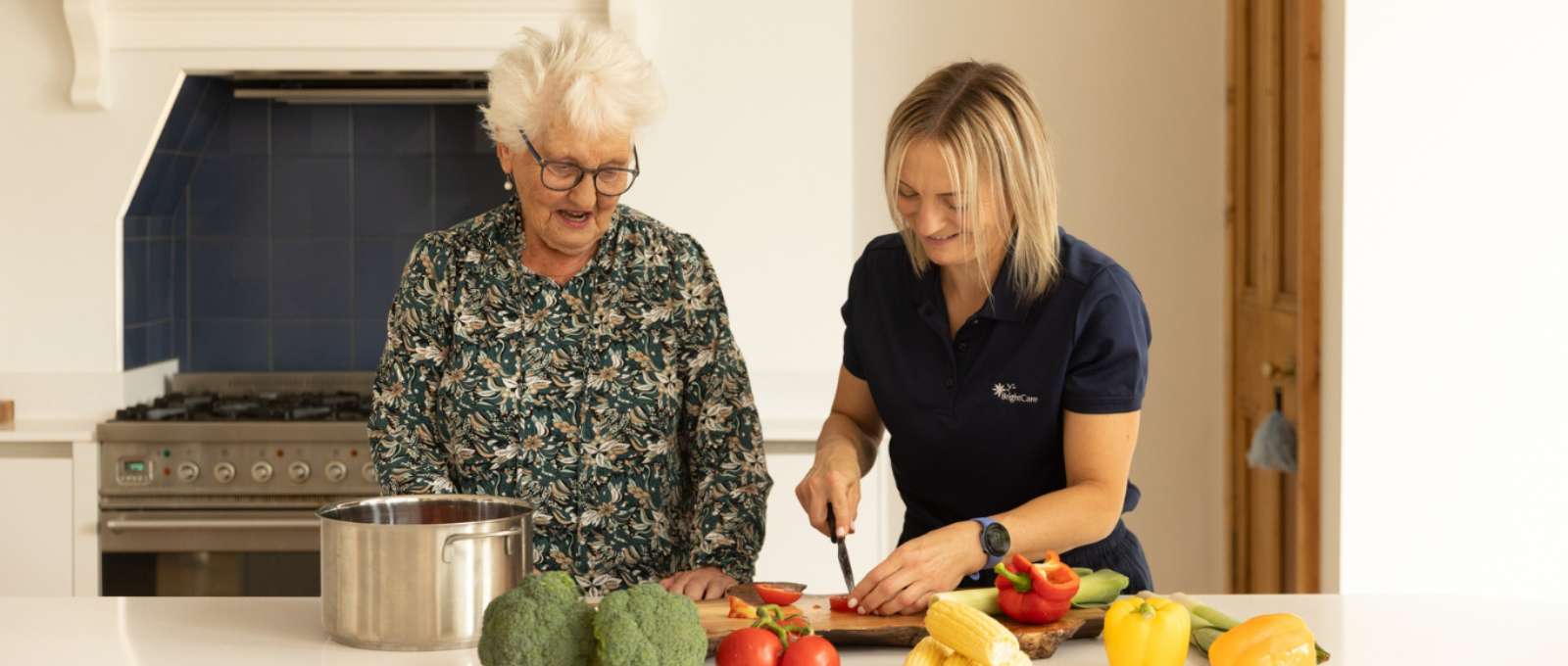 A carer helping to prepare a healthy meal with a client.