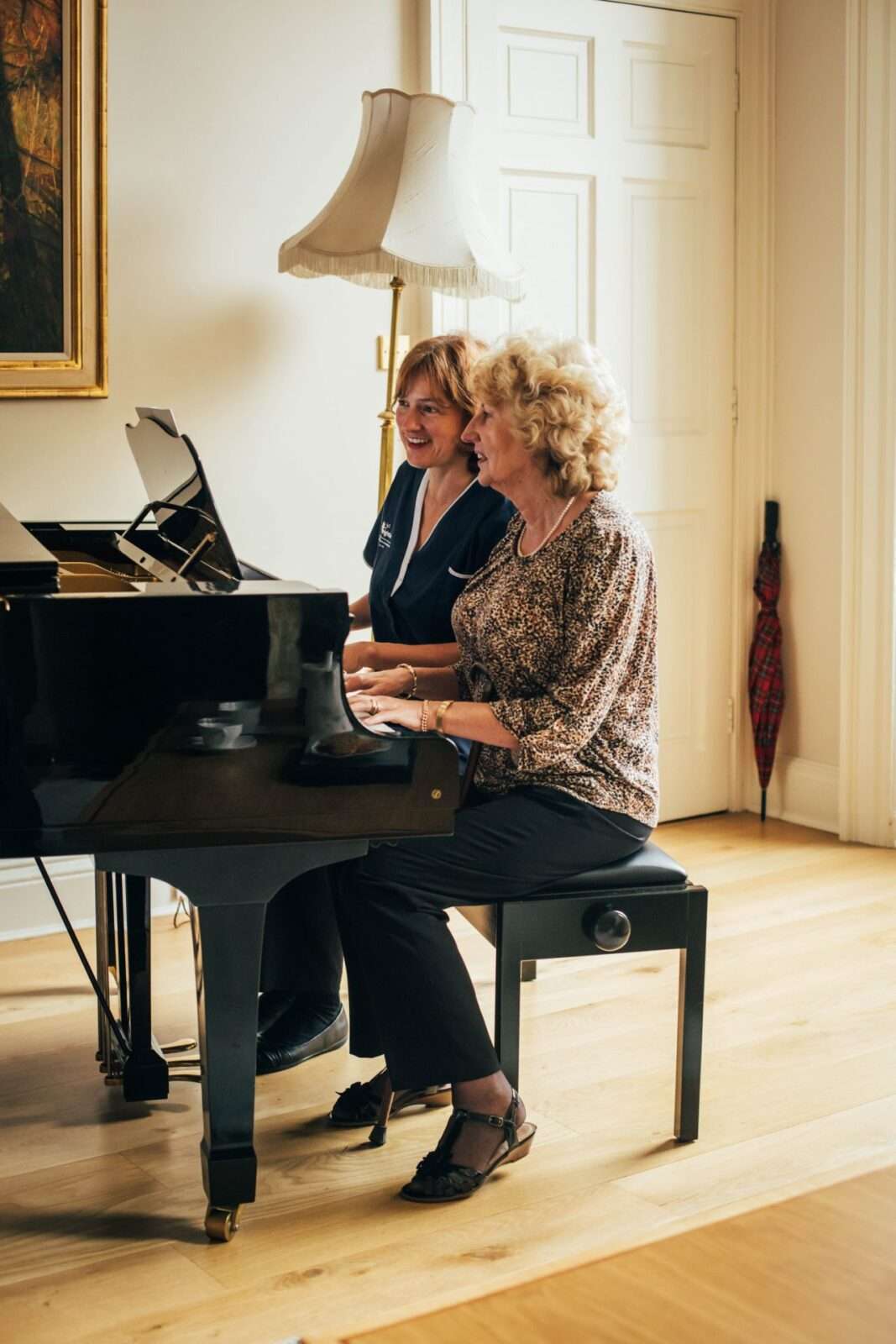 Elderly in-home care, Bright Carer and her client playing piano together