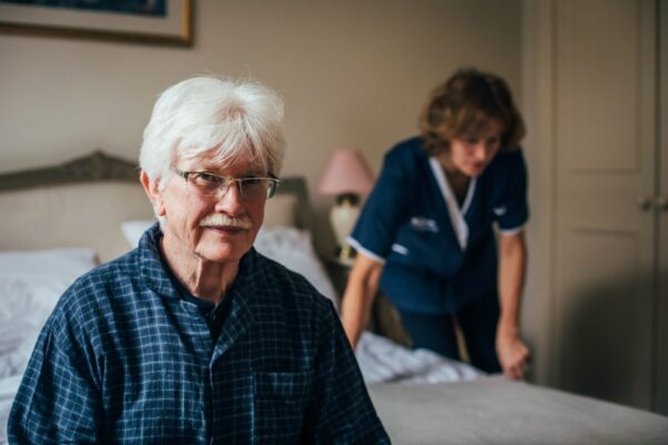 Bright Carer making the bed. (8) Bright Care's client smiling while his Bright Carer adjusts his bed