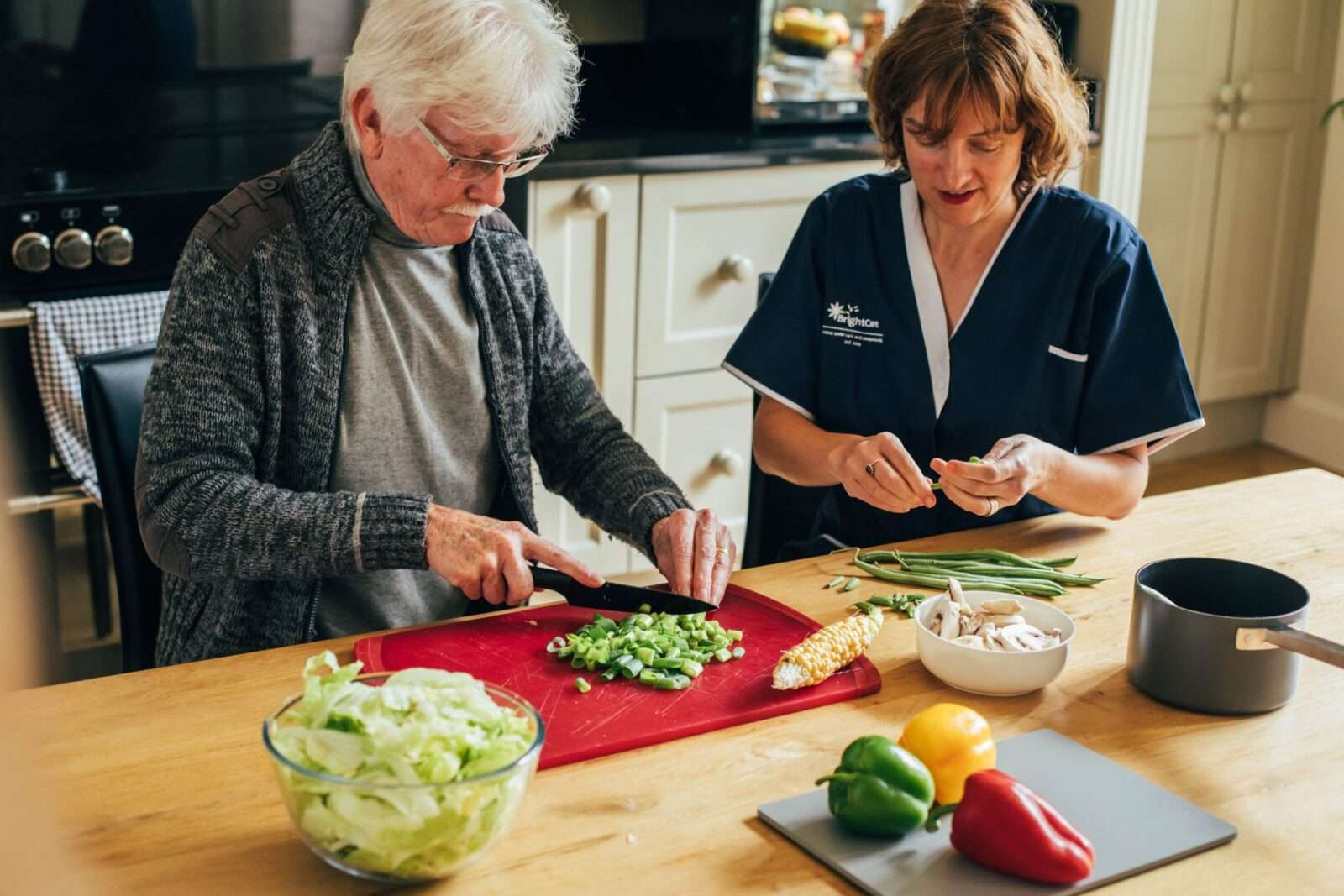 Bright Carer and her client preparing a meal together