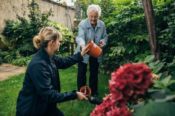 Client and Bright Carer gardening live-in home care, Bright Carer and her client gardening together