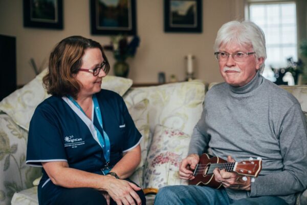 Client playing ukulele with Bright Carer (4) Bright Carer listening to her client playing ukulele