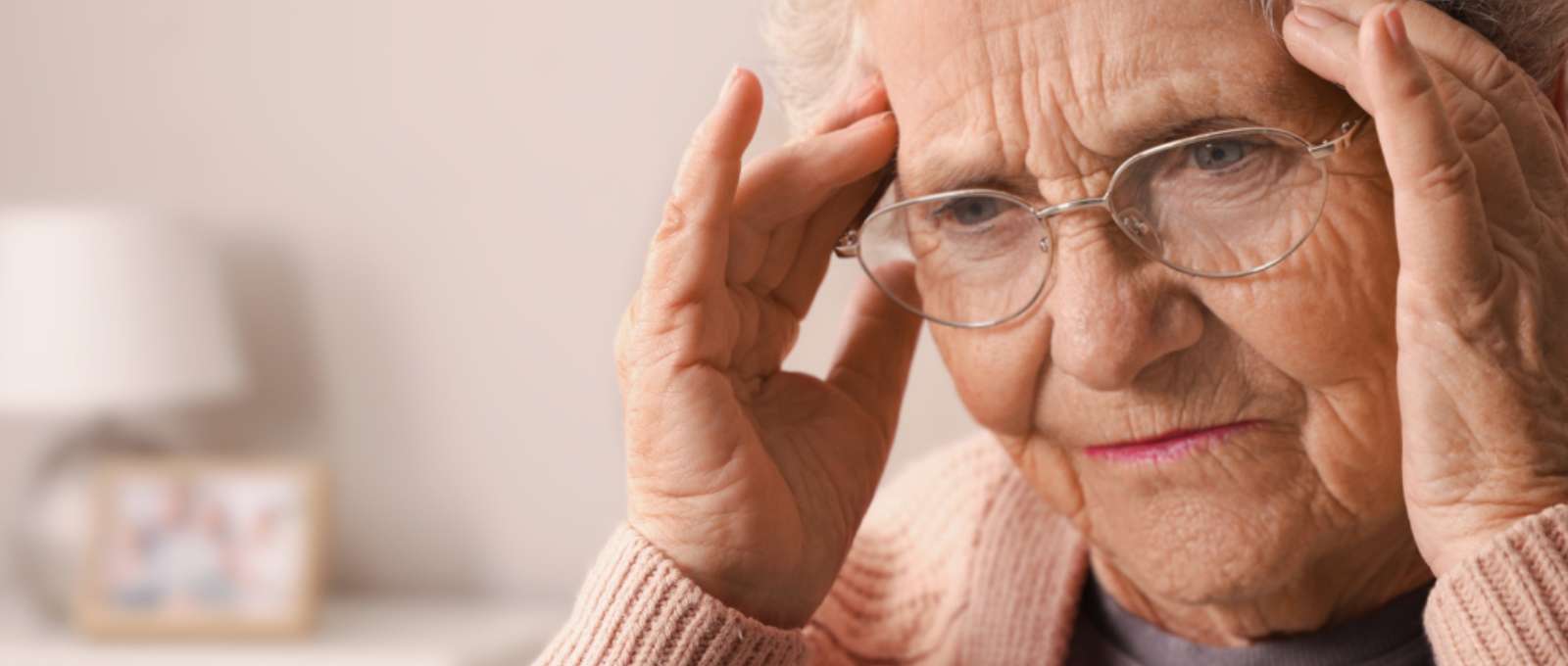 A photo of an elderly lady having trouble remembering something.