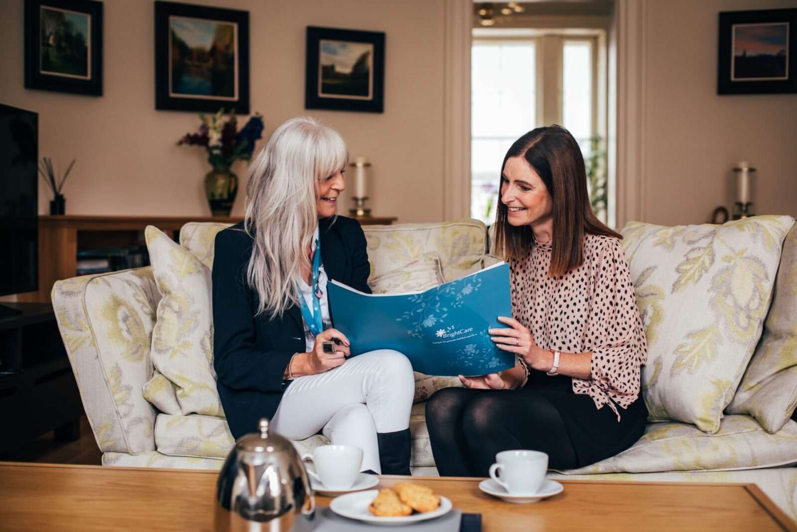 Bright Care Manager explaining the care package to the client 's daughter at the client's house