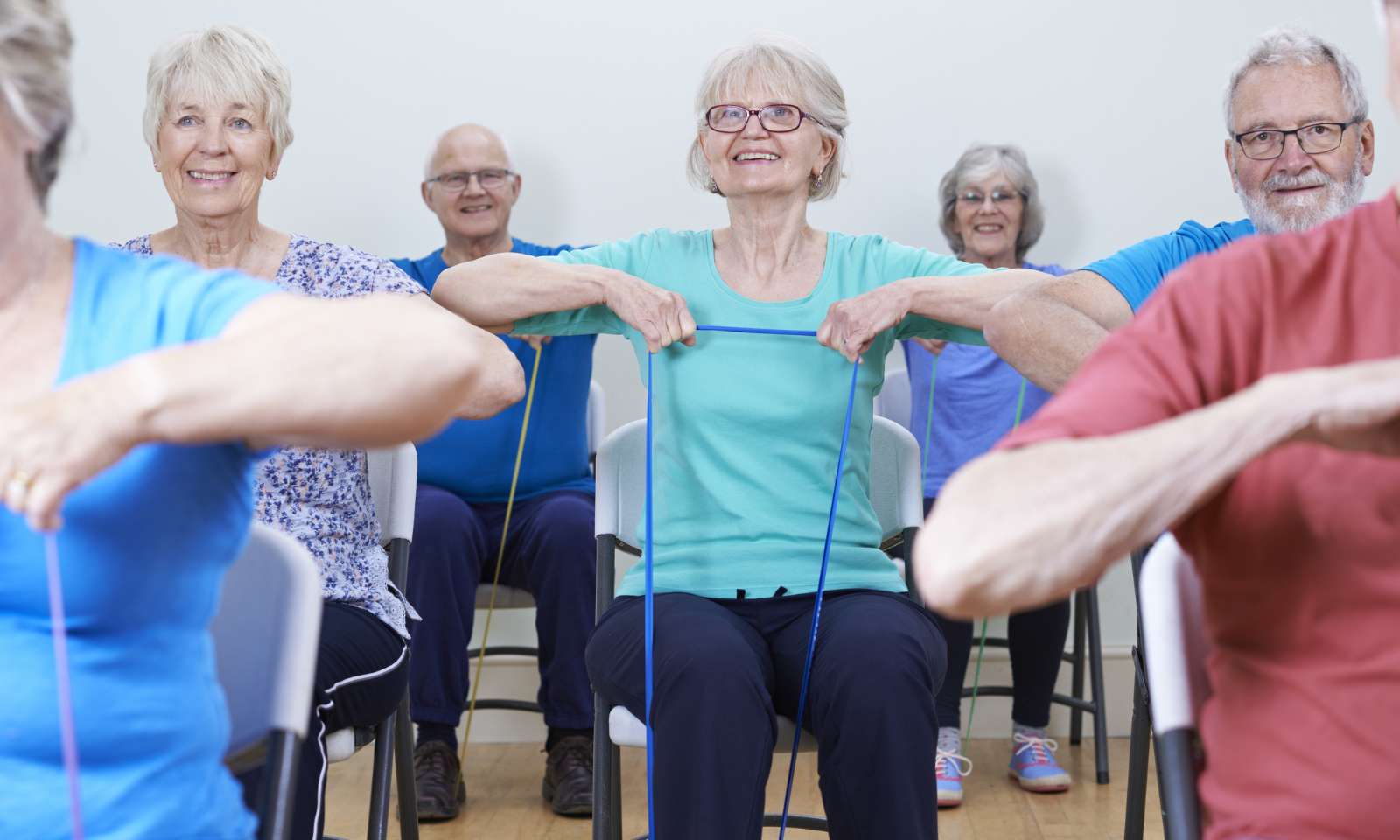 Group Using Resistance Bands In Fitness Class