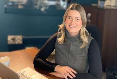 Megan sitting at a desk