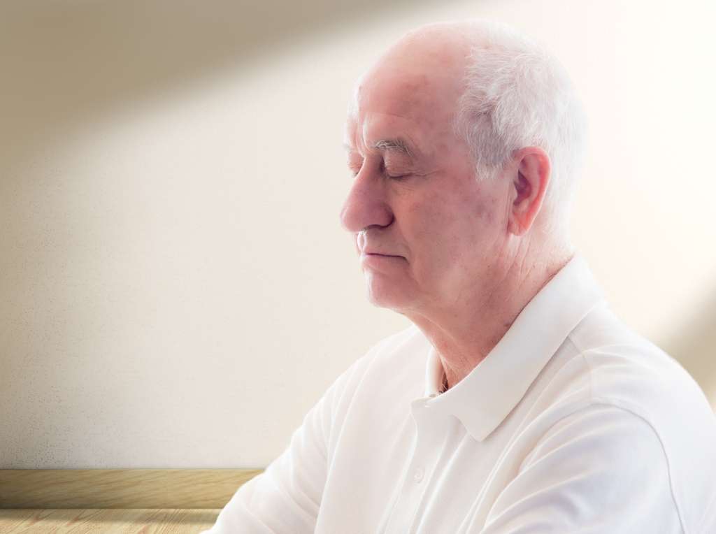 Elderly man with his eyes closed.