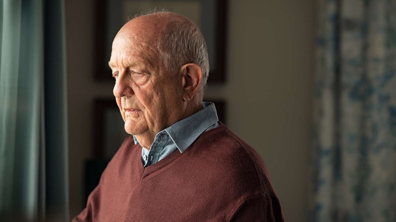An elderly gentlemen experiencing a moment of loneliness.