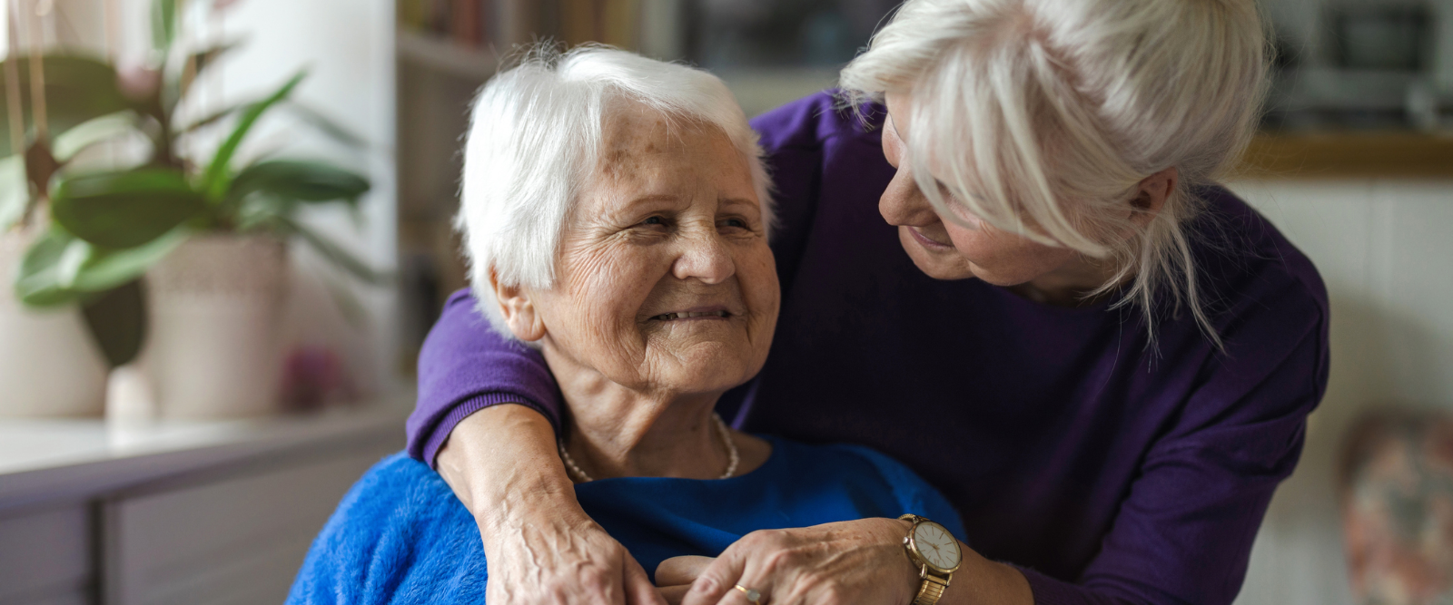Daughter hugging elder mother